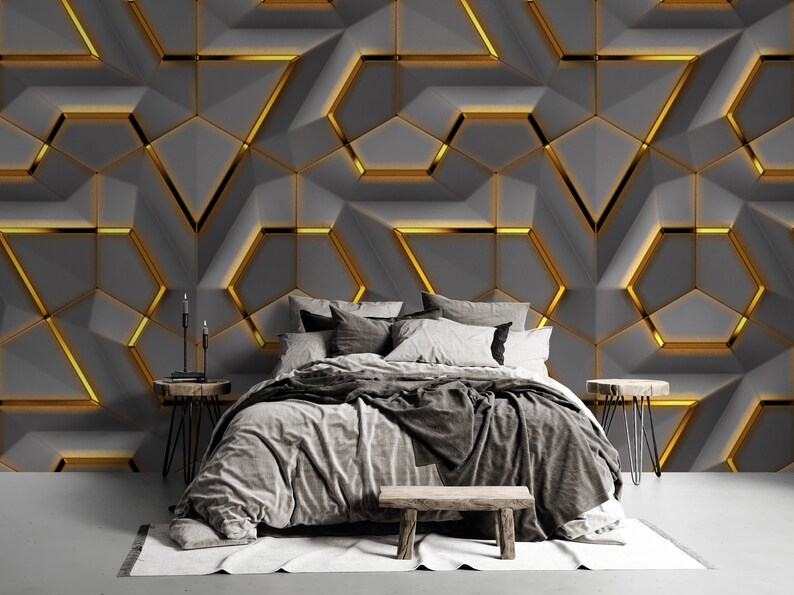 May include: A bed with a grey duvet cover and pillows, set against a wall with a geometric pattern of grey and gold shapes.