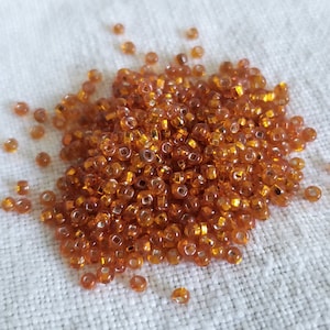 Antique Venetian Seed Beads: Transparent Orange Silver Lined, Size 11/0 (80 Grams)