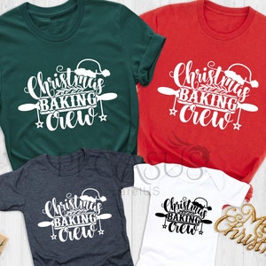 May include: A collection of Christmas-themed t-shirts and a onesie in various colors, including forest green, red, heather dark grey, and white. Each garment features the text "Christmas Baking Crew" in a festive design with a Santa hat and rolling pin.