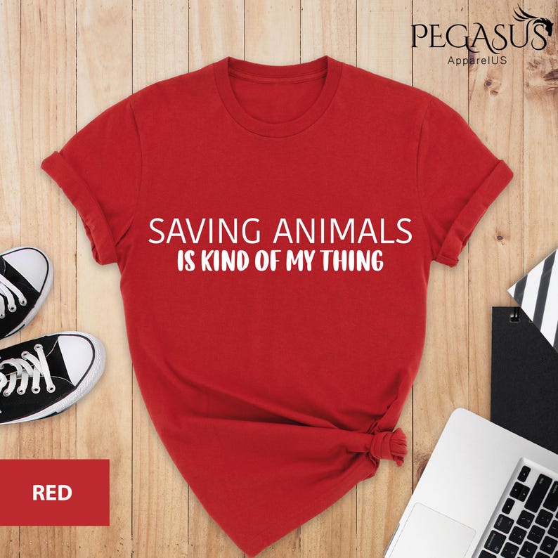 May include: Red t-shirt with the text "Saving Animals is Kind of My Thing" in white lettering.