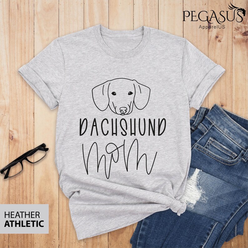 May include: A heather grey t-shirt with a black dachshund silhouette and the text "Dachshund Mom" in black.