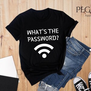May include: Black t-shirt with white text that says "What's the password?" and a white wifi symbol.