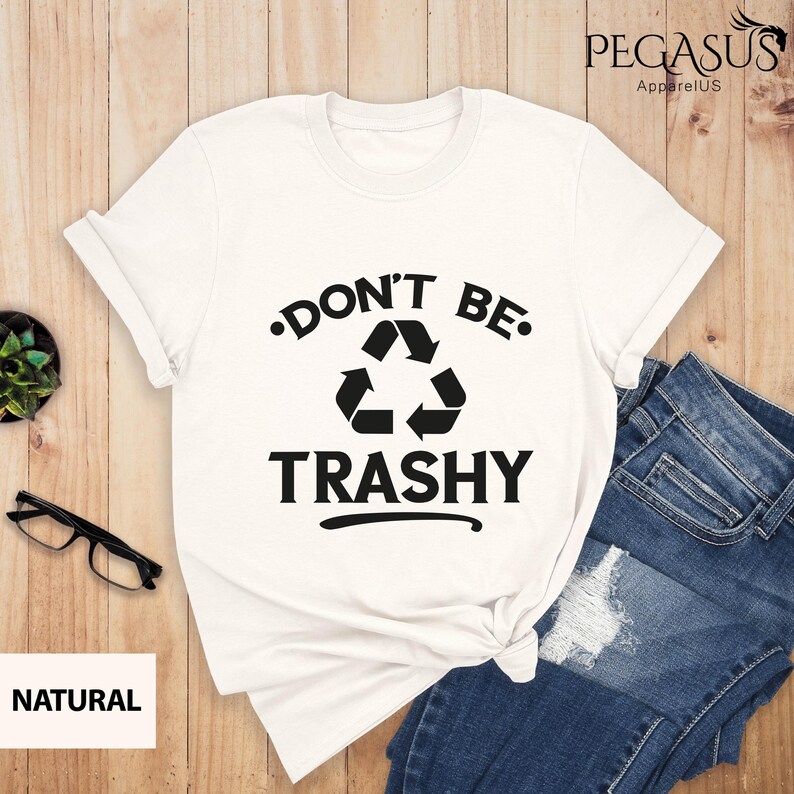 May include: White t-shirt with a black recycle symbol and the text "Don't Be Trashy" printed on it.