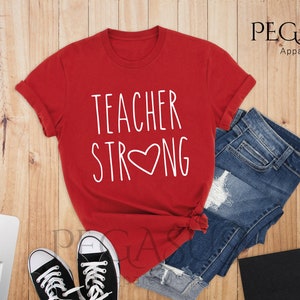 May include: Red t-shirt with white text that says "Teacher Strong" with a heart in the middle of the word "Strong".
