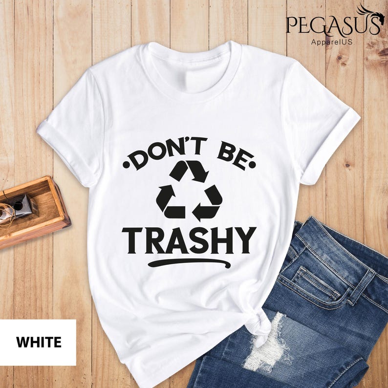 May include: White t-shirt with a black graphic of a recycling symbol and the text "Don't Be Trashy".