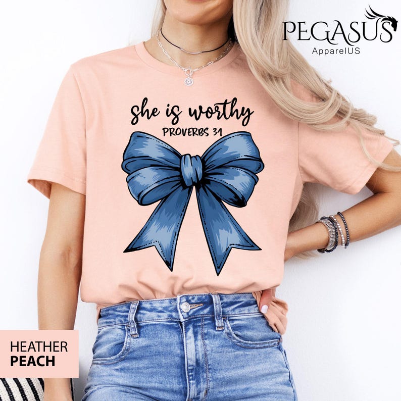 May include: A peach colored t-shirt with a blue bow and the text "She is worthy Proverbs 31" printed on the front.