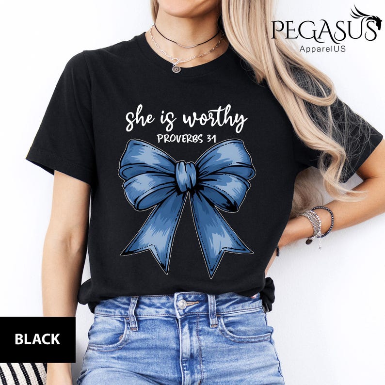 May include: Black t-shirt with a blue bow and the text "She is worthy Proverbs 31" printed on it.