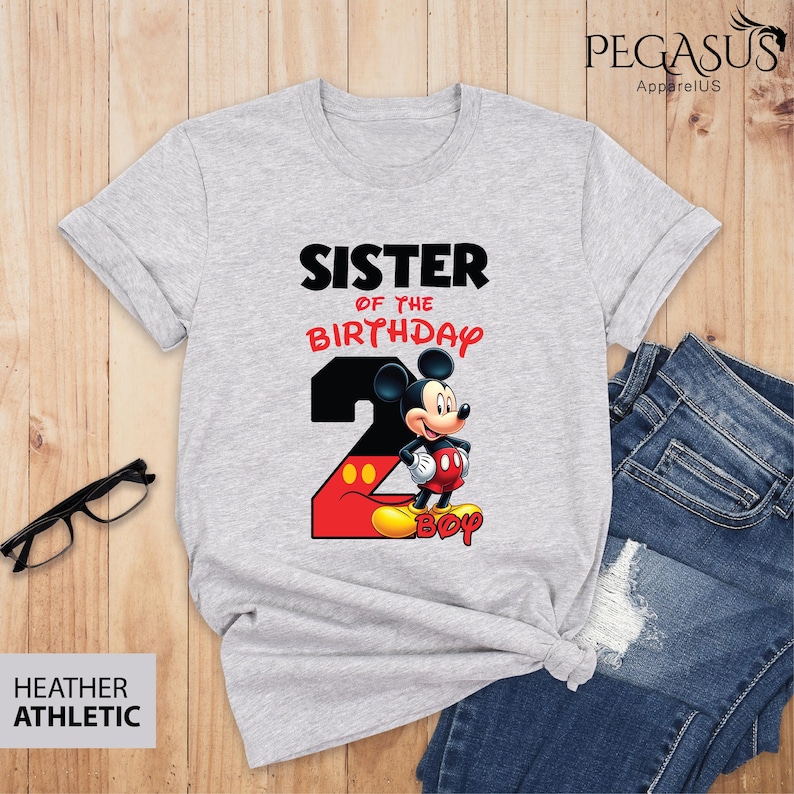 May include: Heather athletic gray t-shirt with the text "SISTER OF THE BIRTHDAY" and a graphic of Mickey Mouse. The number "2" is in black and red, with the word "BOY" at the bottom.