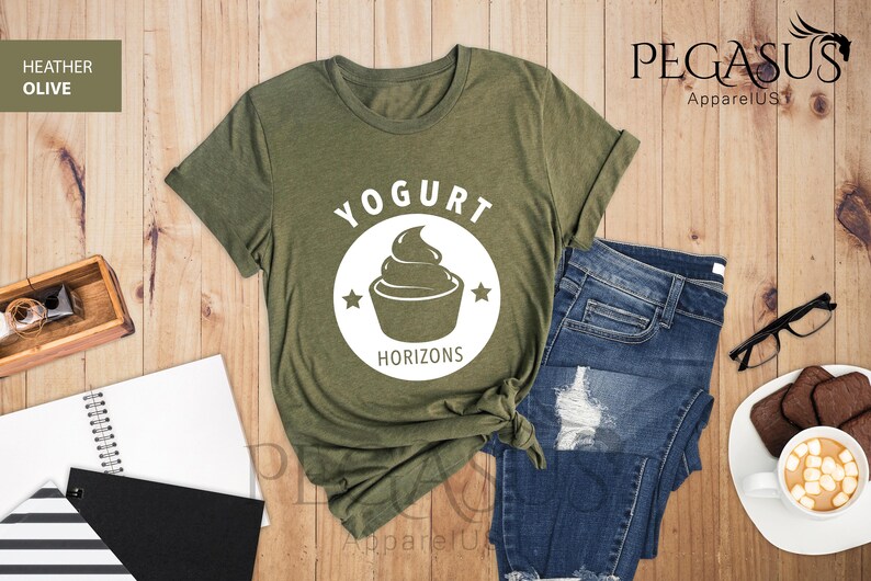 May include: A green t-shirt with a white circle design featuring a yogurt cup and the text "Yogurt Horizons".