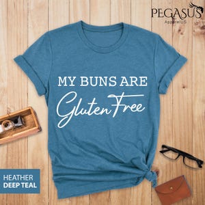 May include: A blue t-shirt with the text "My buns are gluten free" in white.