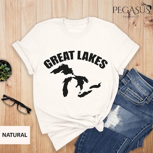 May include: White t-shirt with a black graphic of the Great Lakes and the text "Great Lakes" in a black arc above the map.
