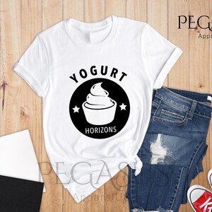 May include: White t-shirt with a black circle graphic that says "Yogurt Horizons" and features a stylized image of a yogurt container with a swirl of yogurt on top.