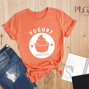 May include: A heather orange t-shirt with a white graphic of a yogurt cup and the text "Yogurt Horizons".