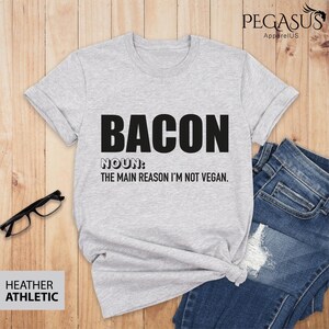 May include: Grey t-shirt with the text "BACON NOUN: THE MAIN REASON I'M NOT VEGAN."