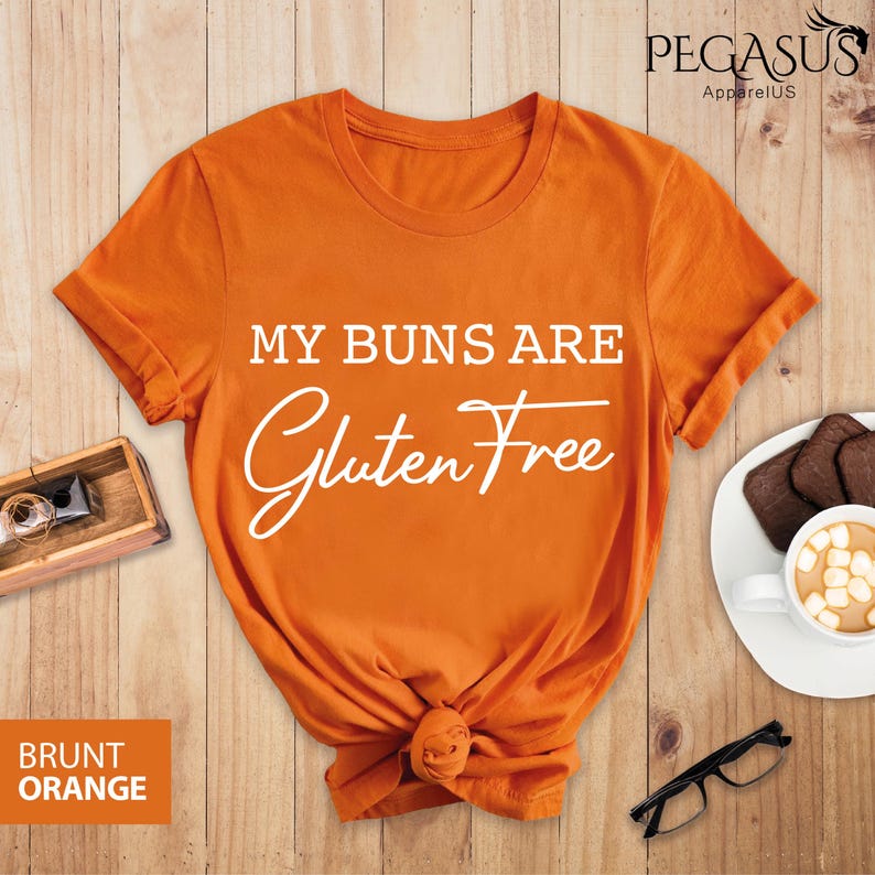 May include: Orange t-shirt with the text "My buns are gluten free" in white lettering.