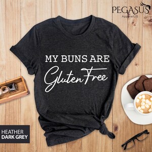 May include: Dark heather grey t-shirt with the text "My buns are gluten free" in white.