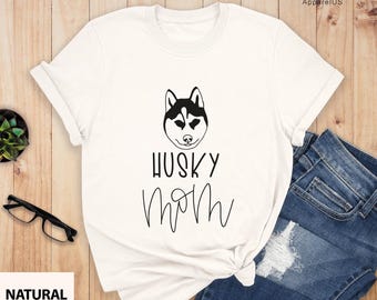 May include: White t-shirt with a black husky silhouette and the text "Husky Mom" in black.