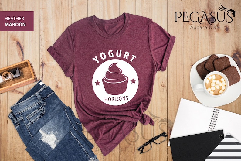 May include: A maroon t-shirt with a white graphic of a yogurt cup and the text "Yogurt Horizons".