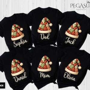 May include: Black t-shirts with a Christmas hat design. Each shirt features a patchwork-style Santa hat with red, green, and cream colors. Names like "Sophia", "Dad", "Jack", "Daniel", "Mom", and "Olivia" are printed below the hat.