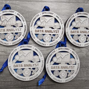 May include: Five circular wooden ornaments featuring a blue background and white laser-cut overlay. Each ornament displays a computer monitor with a graph, a magnifying glass, gears, and the text DATA ANALYST, surrounded by words like INTELLIGENT.