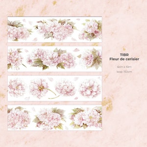 May include: A floral patterned washi tape with pink and white flowers. The tape is labeled "TIBR Fleur de cerisier" with the dimensions "6cm x 10m" and "loop: 150cm".