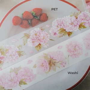 May include: Two rolls of decorative tape with a floral design. The top roll is labeled "PET" and the bottom roll is labeled "Washi".