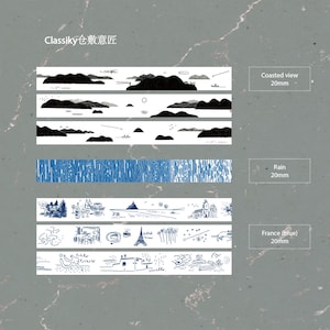 May include: Decorative washi tape set featuring landscape and pattern designs. Includes black and white coastal views, blue rain patterns, and blue illustrations of France, including the Eiffel Tower. Each tape is 20mm wide.