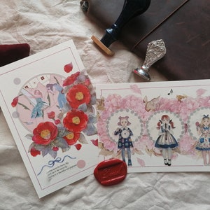 May include: Two cards with watercolor illustrations. The first card features a pink and blue illustration of a woman with wings flying in a circle of flowers. The second card features three women in dresses with floral accents. The text on the first card reads "Waking up as the dawn breaks, I look up at the morning sky, Feeling as beautiful and profound as the flowers in my garden."