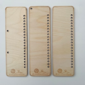 May include: Three wooden loom boards with rows of holes for weaving. Each board has a small yarn ball and heart graphic with the text "@LaurettecraftsUK".