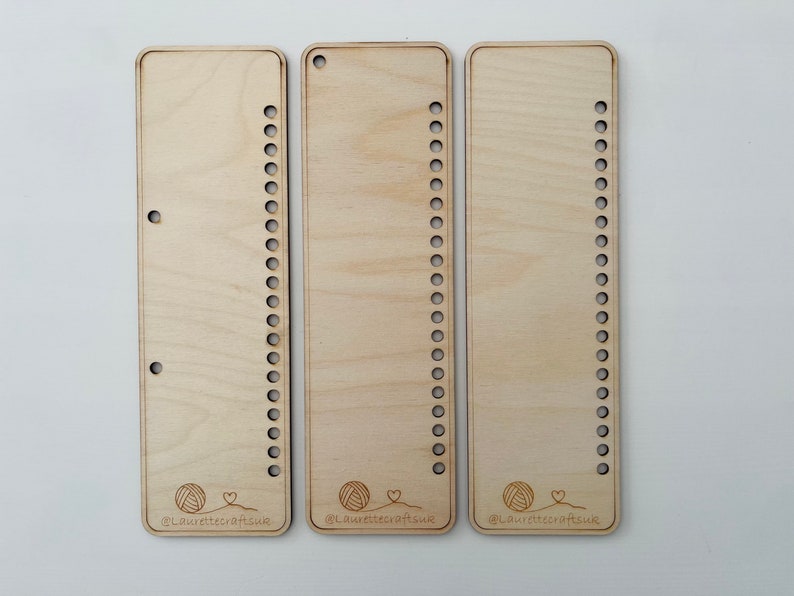 May include: Three wooden loom boards with rows of holes for weaving. Each board has a small yarn ball and heart graphic with the text "@LaurettecraftsUK".