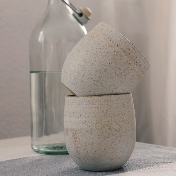 beige, bulbous ceramic mug, handleless, hand-turned from the ceramics studio, stoneware ceramics