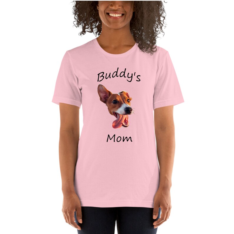 May include: Pink t-shirt with a graphic of a dog's head and the text "Buddy's Mom"