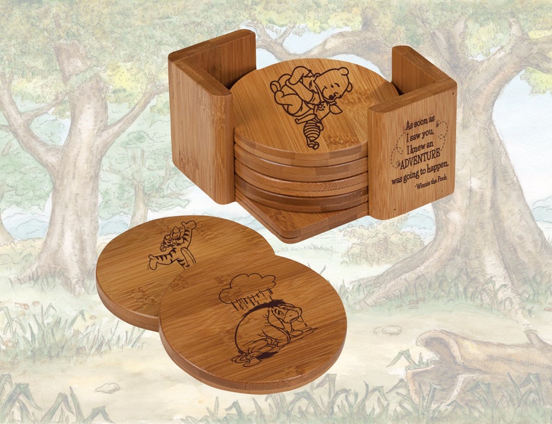 May include: Set of six bamboo coasters featuring Winnie the Pooh and Piglet characters. The coasters are engraved with images of the characters and a quote from the book. The coasters come with a bamboo holder.