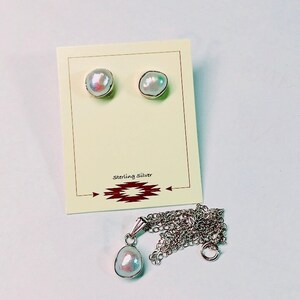 May include: A set of pearl earrings and a pearl pendant necklace. The earrings and pendant are made of sterling silver and feature a white pearl.