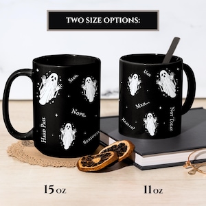 May include: Two black ceramic mugs featuring a white ghost pattern and text including "Sigh," "Nope," "Hard Pass," "Seriously," "Ugh," "Meh," "Really?" and "Not Today." The mugs are labeled with size options of 15 oz and 11 oz respectively.