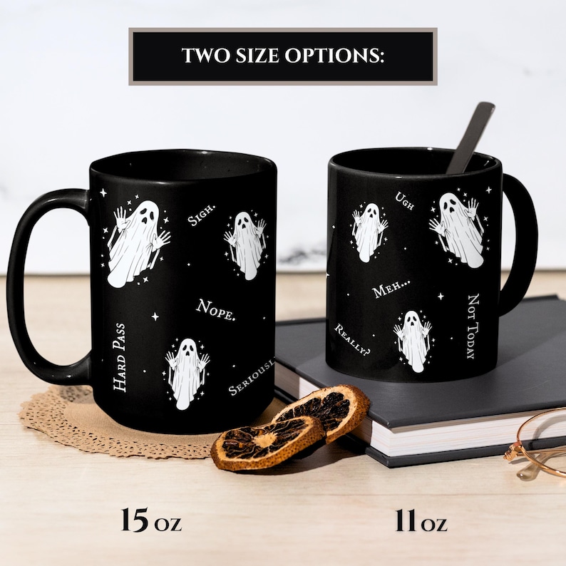 May include: Two black ceramic mugs featuring a white ghost pattern and text including "Sigh," "Nope," "Hard Pass," "Seriously," "Ugh," "Meh," "Really?" and "Not Today." The mugs are labeled with size options of 15 oz and 11 oz respectively.