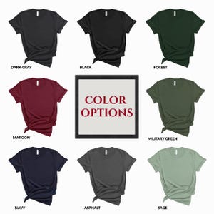 May include: A collection of short-sleeved t-shirts in various colors, including dark gray, black, forest green, maroon, military green, navy, asphalt, and sage. A central graphic displays the text "COLOR OPTIONS".