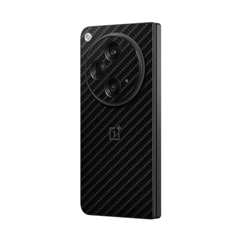 May include: A black smartphone with a carbon fiber texture on the back. The phone has a circular camera module with three lenses and a flash. The OnePlus logo is visible at the bottom.