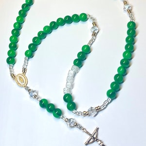 Custom green and gold family name rosary add up to 5 names.