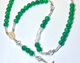 Custom green and gold family name rosary add up to 5 names.