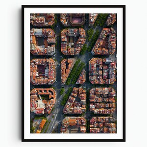 May include: A framed aerial photograph of a city grid featuring dense urban blocks with orange-tiled roofs, rectangular building layouts, and intersecting streets lined with green trees, all captured from a high-altitude vertical perspective.