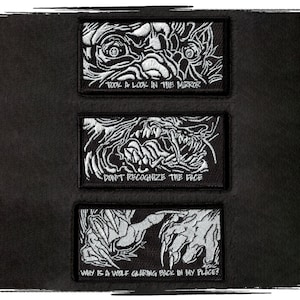 May include: Three black and white embroidered patches featuring a monster face and text. The top patch reads "Took a look in the mirror". The middle patch reads "Don't recognise the face". The bottom patch reads "Why is a wolf glaring back in my place?"