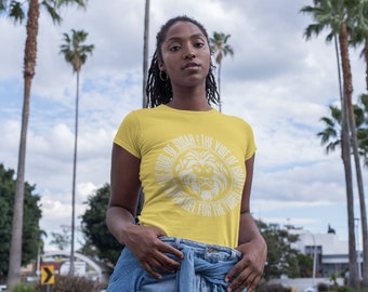 May include: A woman wearing a yellow t-shirt with a white lion graphic and the text "The Soul of Judah: The Vibe of Israel. United for the Tribe".