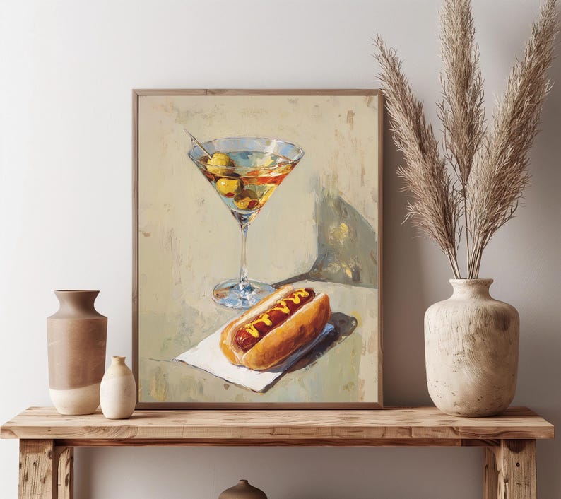May include: A still-life painting featuring a martini glass filled with olives and a hot dog with mustard on a white napkin. The artwork has a vintage aesthetic with warm tones and soft lighting.