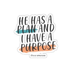 May include: A sticker with the text "He has a plan and I have a purpose" in black lettering on a white background. The text is surrounded by a blue and orange brushstroke design. The sticker also includes the text "@everamerican" in black lettering at the bottom.