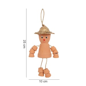 May include: A terracotta doll-like ornament, 25 cm tall and 10 cm wide, with a straw hat and string arms and legs. The face has painted eyes and a red nose. The arms and legs are made of small terracotta pots.