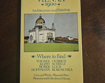 May include: A vintage book titled "Vienna 1900 Architecture and Painting" by Christian M. Nebehay. The cover features an illustration of a building with a dome and text listing artists and locations in Vienna.