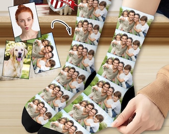 May include: A pair of white socks with a repeating pattern of a family photo. The photo shows a group of people, including adults and children, smiling and hugging. The socks are made in the USA.