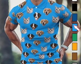 May include: A blue polo shirt with a repeating pattern of dog and cat faces. The shirt has a button-up collar and short sleeves.
