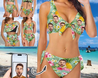 May include: A light green two-piece swimsuit with a tropical floral and pineapple pattern. The swimsuit features a repeating pattern of a surprised face. The top has a bow in the center. The bottom has tie sides.